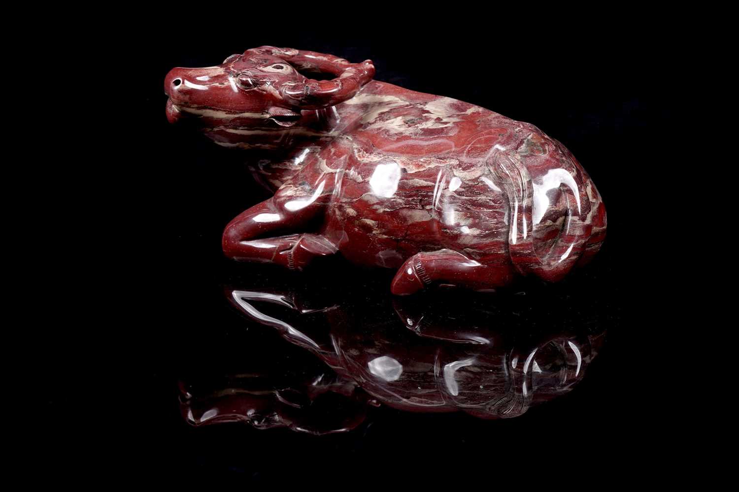 Lot 353 - A Chinese carved red jasper water buffalo