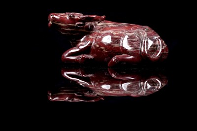 Lot 353 - A Chinese carved red jasper water buffalo