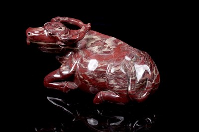 Lot 353 - A Chinese carved red jasper water buffalo