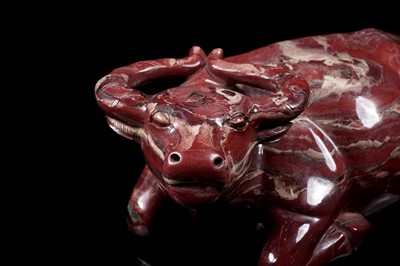 Lot 353 - A Chinese carved red jasper water buffalo