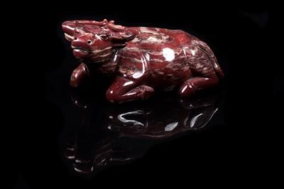 Lot 353 - A Chinese carved red jasper water buffalo