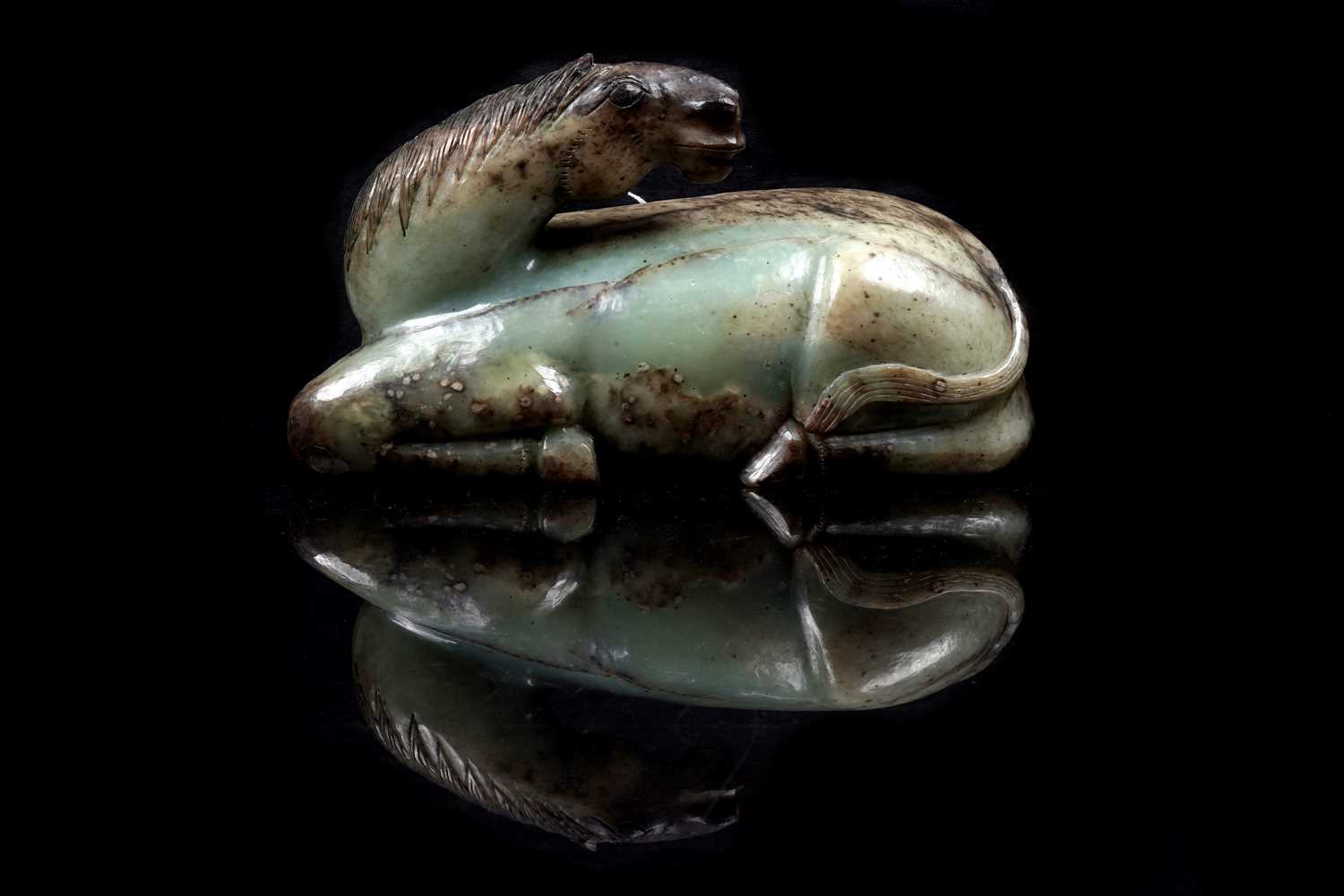 Lot 354 - A Chinese carved jade horse