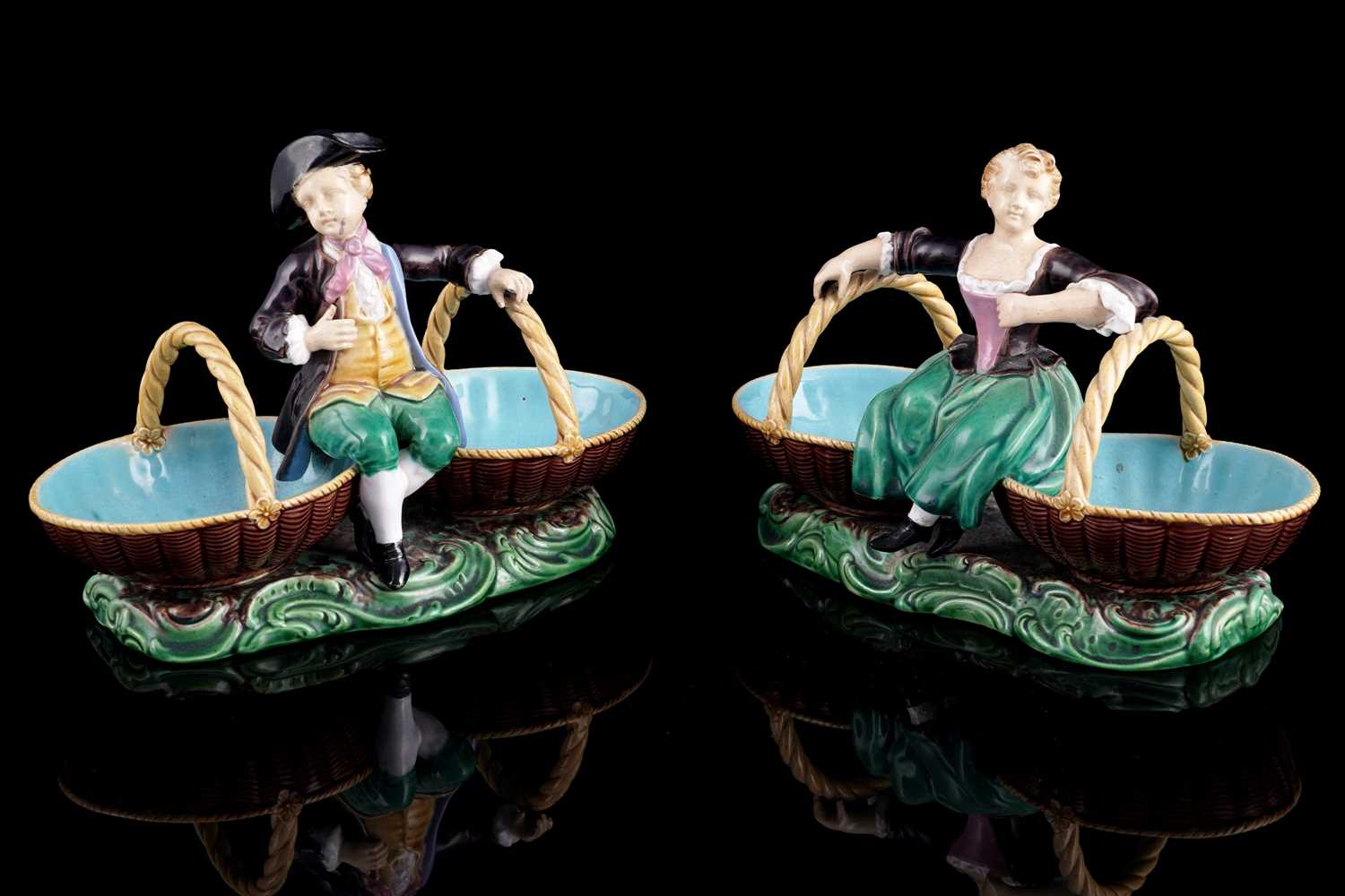 Lot 412 - A pair of Minton majolica figural sweetmeat baskets