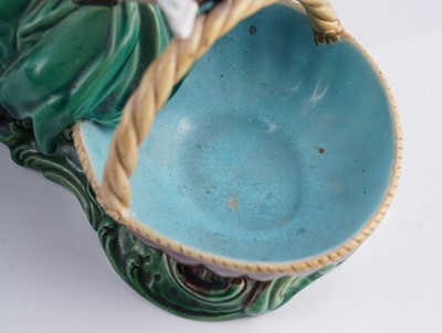 Lot 412 - A pair of Minton majolica figural sweetmeat baskets