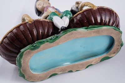 Lot 412 - A pair of Minton majolica figural sweetmeat baskets