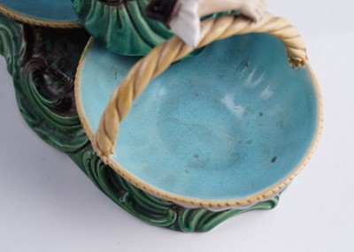 Lot 412 - A pair of Minton majolica figural sweetmeat baskets