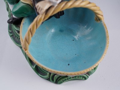 Lot 412 - A pair of Minton majolica figural sweetmeat baskets