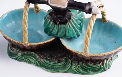 Lot 412 - A pair of Minton majolica figural sweetmeat baskets