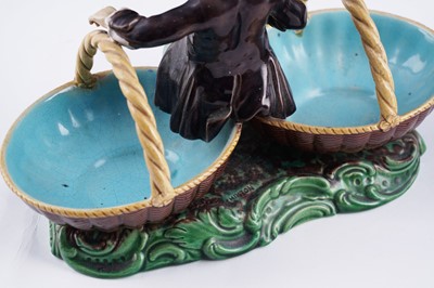 Lot 412 - A pair of Minton majolica figural sweetmeat baskets