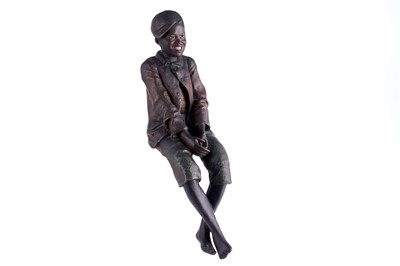 Lot 465 - A Goldscheider style figure of a seated boy