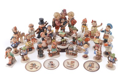 Lot 308 - Twenty-five Hummel ceramic figures; and four small plates