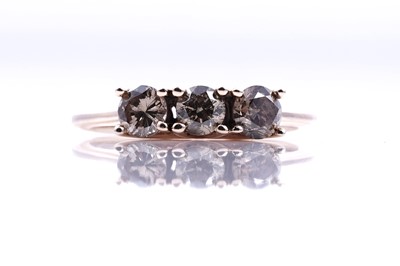 Lot 207 - A contemporary three-stone champagne diamond ring