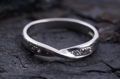 Lot 223 - A contemporary diamond half hoop eternity ring