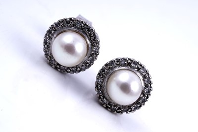 Lot 224 - A contemporary pair of diamond and cultured pearl stud earrings