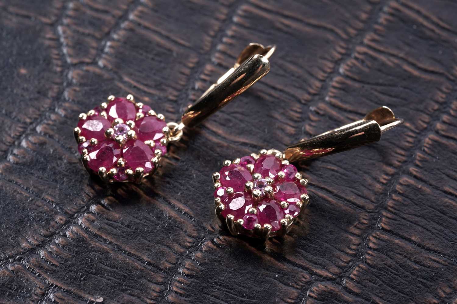 Lot 58 - A pair of ruby flowerhead pattern earrings