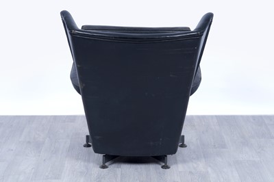 Lot 64 - A 1950’s black leather wingback revolving armchair