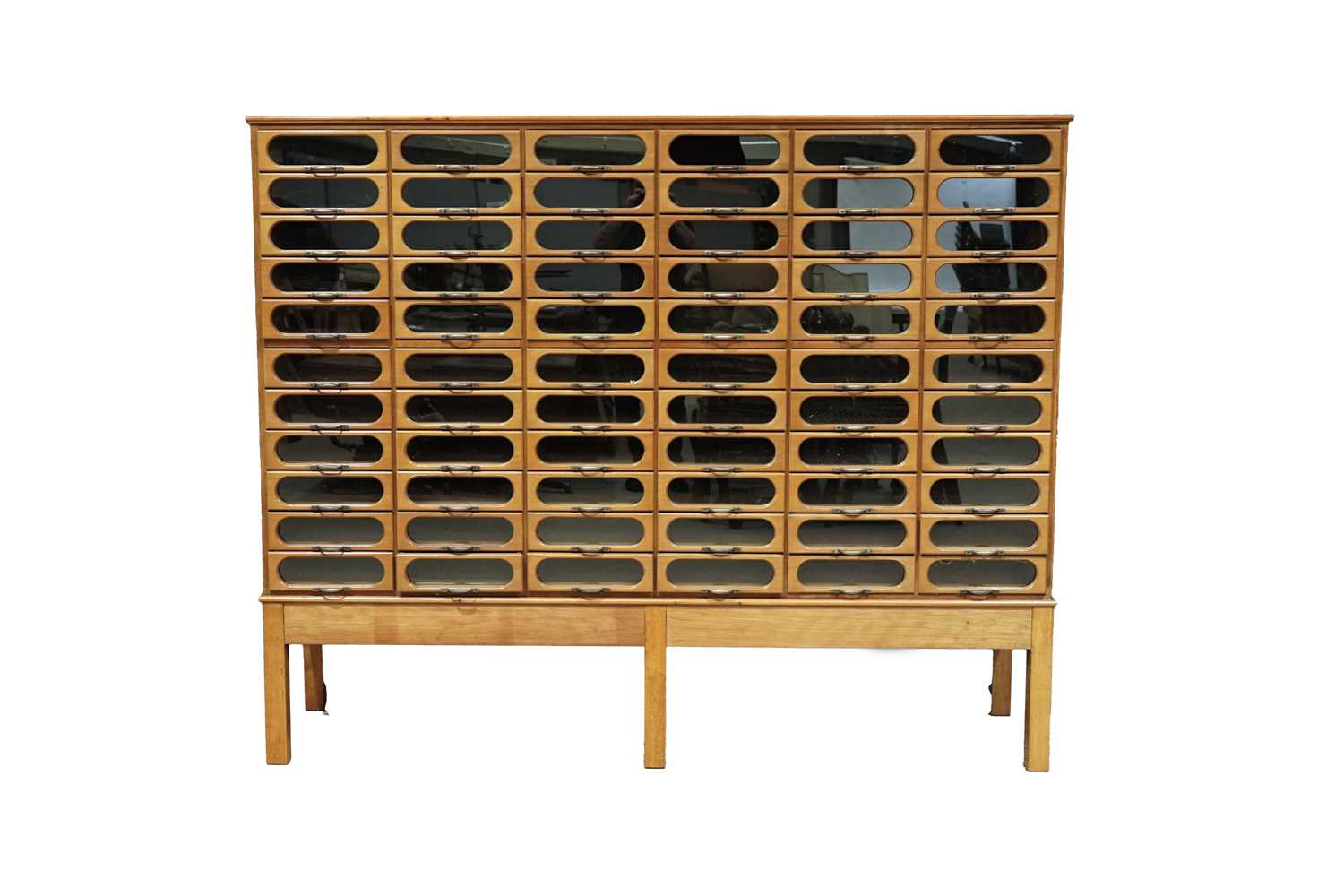Lot 615 - An early 20th Century beech haberdashery cabinet