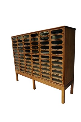 Lot 615 - An early 20th Century beech haberdashery cabinet