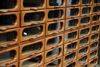 Lot 615 - An early 20th Century beech haberdashery cabinet