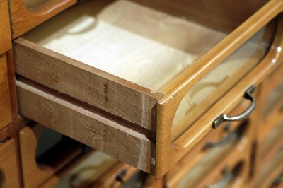 Lot 615 - An early 20th Century beech haberdashery cabinet