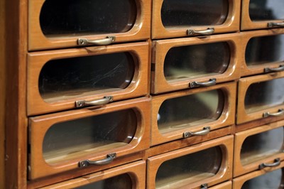 Lot 615 - An early 20th Century beech haberdashery cabinet