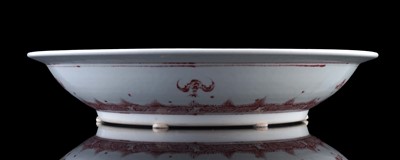 Lot 332 - A Chinese liver-red decorated charger