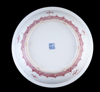Lot 332 - A Chinese liver-red decorated charger