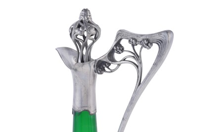 Lot 490 - WMF: and early 20th Century Art Nouveau pewter and green glass claret jug