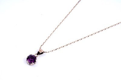 Lot 250 - A purple paste pendant on chain