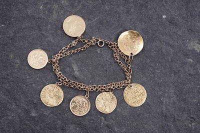 Lot 296 - A fancy figaro-link bracelet; and seven pendant coins