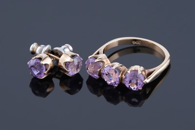Lot 257 - An amethyst three-stone ring; and matching stud earrings