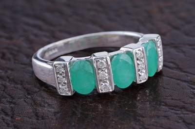 Lot 181 - A contemporary emerald and diamond ring