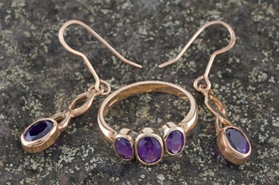 Lot 183 - A modern amethyst three-stone ring; and a pair of amethyst pendant earrings