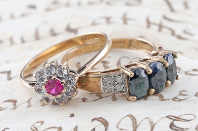 Lot 185 - A contemporary three stone sapphire and diamond ring; and a flowerhead pattern ring