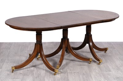 Lot 20 - A triple pedestal oak D-end dining table