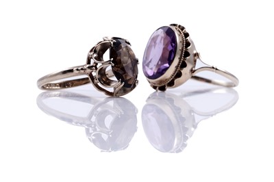 Lot 204 - Modern amethyst and smoky quartz dress rings