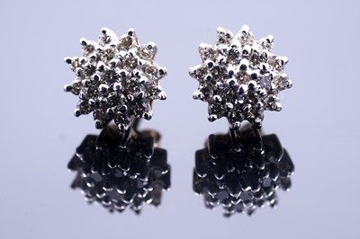 Lot 157 - A pair of diamond flowerhead cluster earrings
