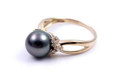 Lot 159 - A contemporary cultured black pearl and diamond ring