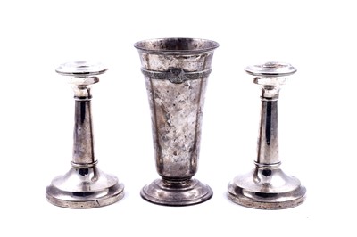 Lot 334 - An Elizabeth II silver Lindisfarne pattern vase; and a pair of candlestick holders
