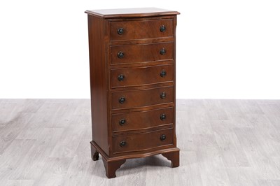 Lot 31 - A reproduction serpentine fronted tall chest of six drawers