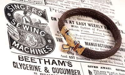 Lot 101 - A 19th Century French hairwork bracelet with loveheart charm