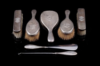 Lot 213 - An Edwardian lady's silver mirror and brush set; and associated button hook and shoe-horn pair