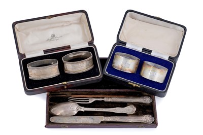 Lot 214 - A matched silver mounted knife, fork and spoon set; and two pairs of silver napkin rings