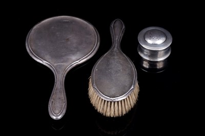 Lot 227 - An Edwardian Arts and Crafts balm pot; and an early 20th Century silver mirror and brush set