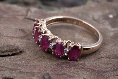 Lot 43 - A ruby and diamond half hoop eternity ring