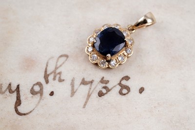 Lot 90 - A sapphire and diamond flower pattrn pendant