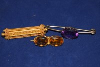 Lot 20 - A citrine bar brooch set yellow metal; an...